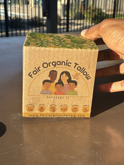 Fair Organic Tallow branded packaging held by hand outdoors.
