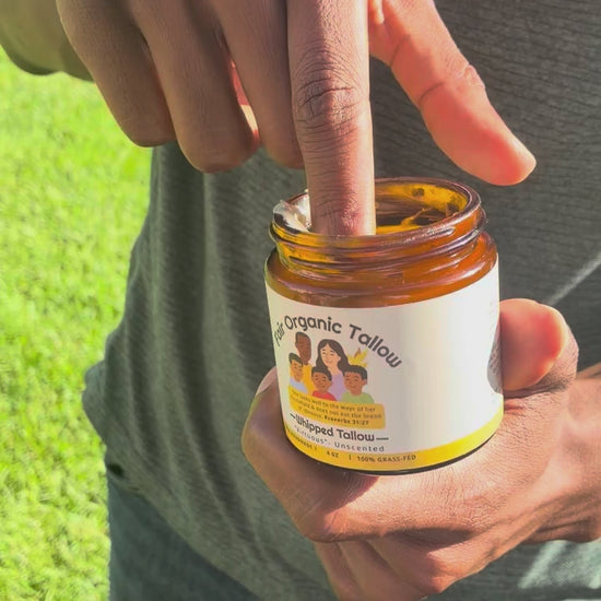A small amount of Virtuous balm is scooped from the jar and massaged into a forearm.