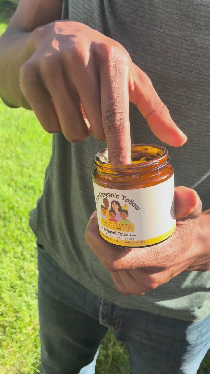 A small amount of Virtuous balm is scooped from the jar and massaged into a forearm.