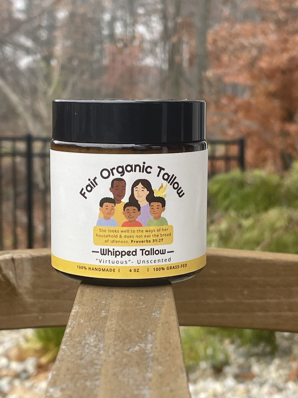Virtuous unscented whipped tallow balm in a 4 oz amber jar with a black lid, photographed outdoors.
