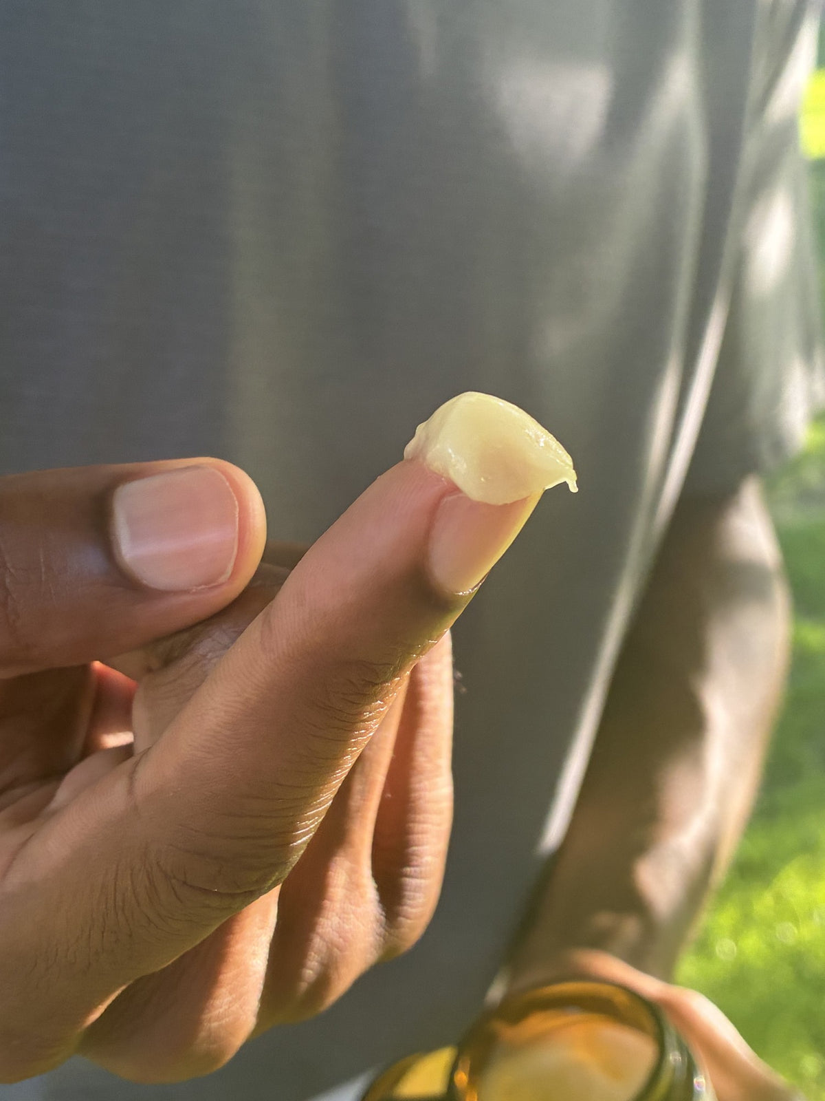A small amount of Virtuous balm on a fingertip.