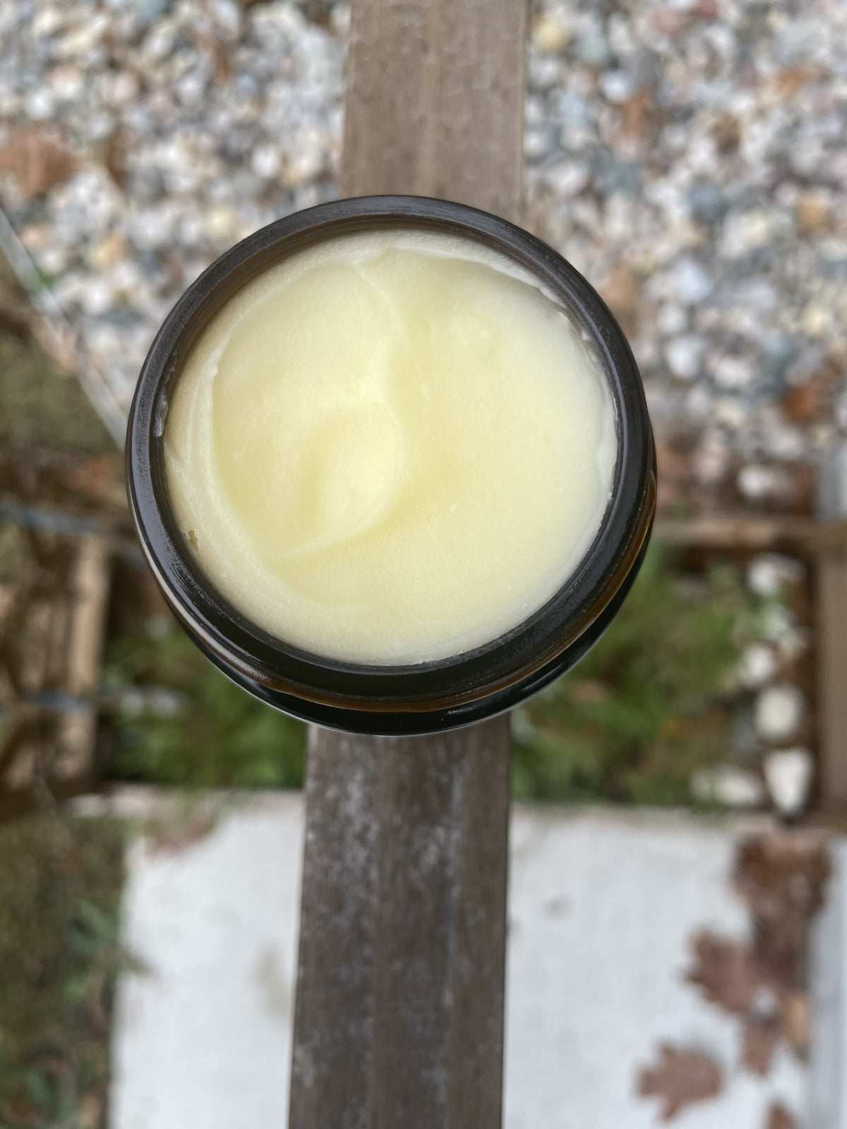 An open jar showing the whipped texture of Virtuous tallow balm.